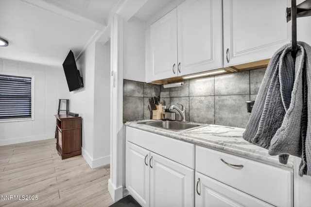 a kitchen with a sink a refrigerator and cabinets