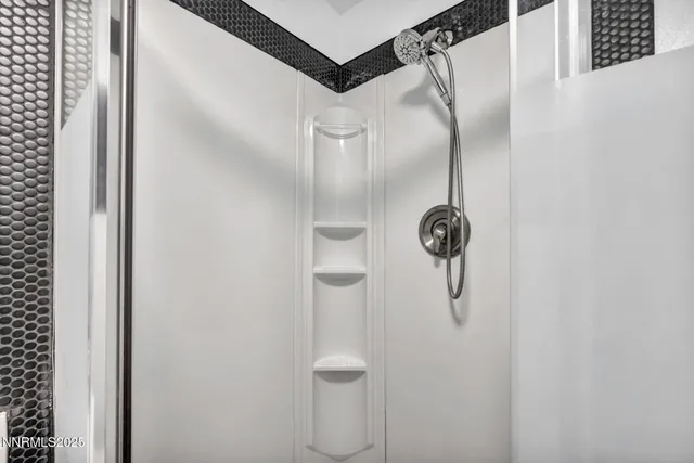 a bathroom with a glass shower door