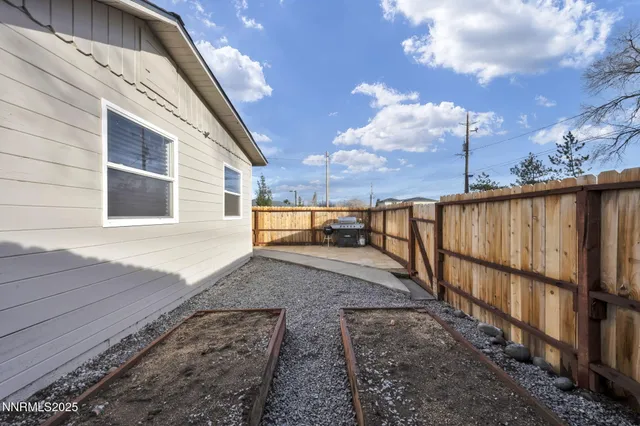 a view of a backyard with wooden fence