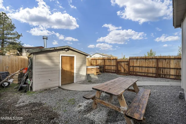 a view of a terrace with a table and chairs