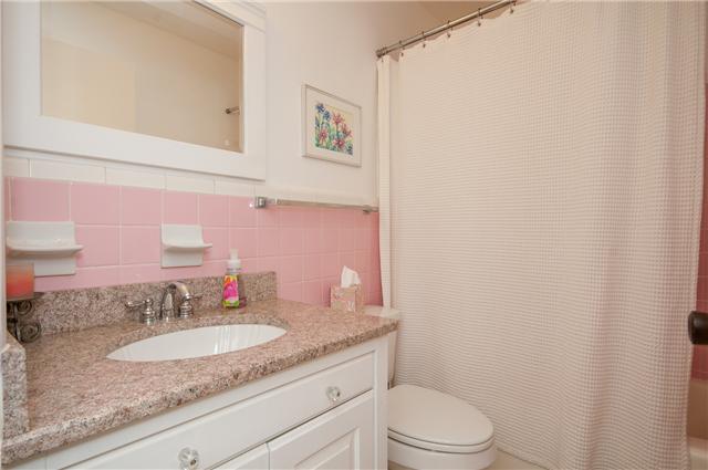 350 Stable Road Franklin, TN 37069 - Photo 13 of 18 Classic Retro Pink tiled bath with solid surface vanity top and under mounted sink.