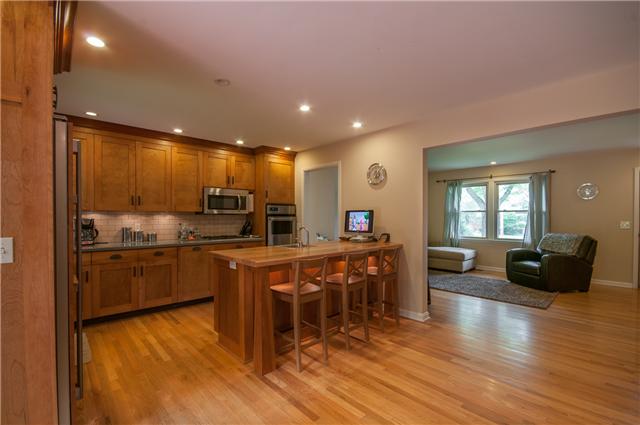 350 Stable Road Franklin, TN 37069 - Photo 5 of 18 Impressive Arts & Crafts Kitchen features custom shaker cabinets, solid surface counters,subway backsplash, gas cooktop, double ovens, and a butcher block bar w/ stools & bar sink.