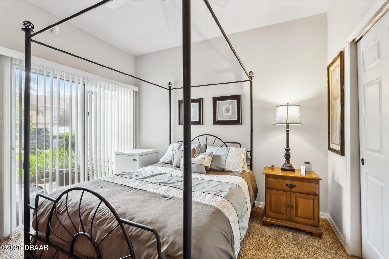 3617 Romea Circle New Smyrna Beach, FL 32168 - Photo 11 of 28 a bed room with a bed and a chandelier