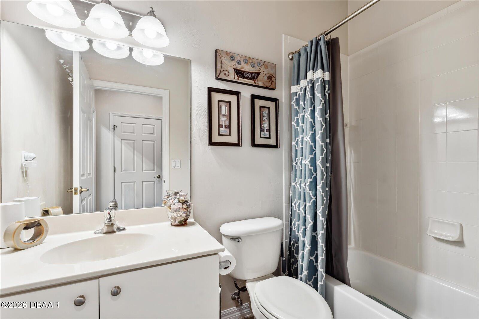 3617 Romea Circle New Smyrna Beach, FL 32168 - Photo 12 of 28 a bathroom with a sink a toilet a mirror and shower