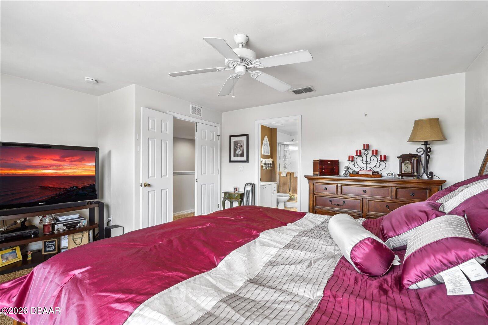 3617 Romea Circle New Smyrna Beach, FL 32168 - Photo 16 of 28 a bedroom with a bed and a flat screen tv