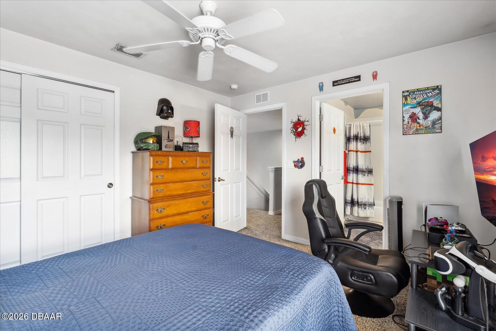 3617 Romea Circle New Smyrna Beach, FL 32168 - Photo 19 of 28 a bedroom with a bed a desk and chair with the wooden floor