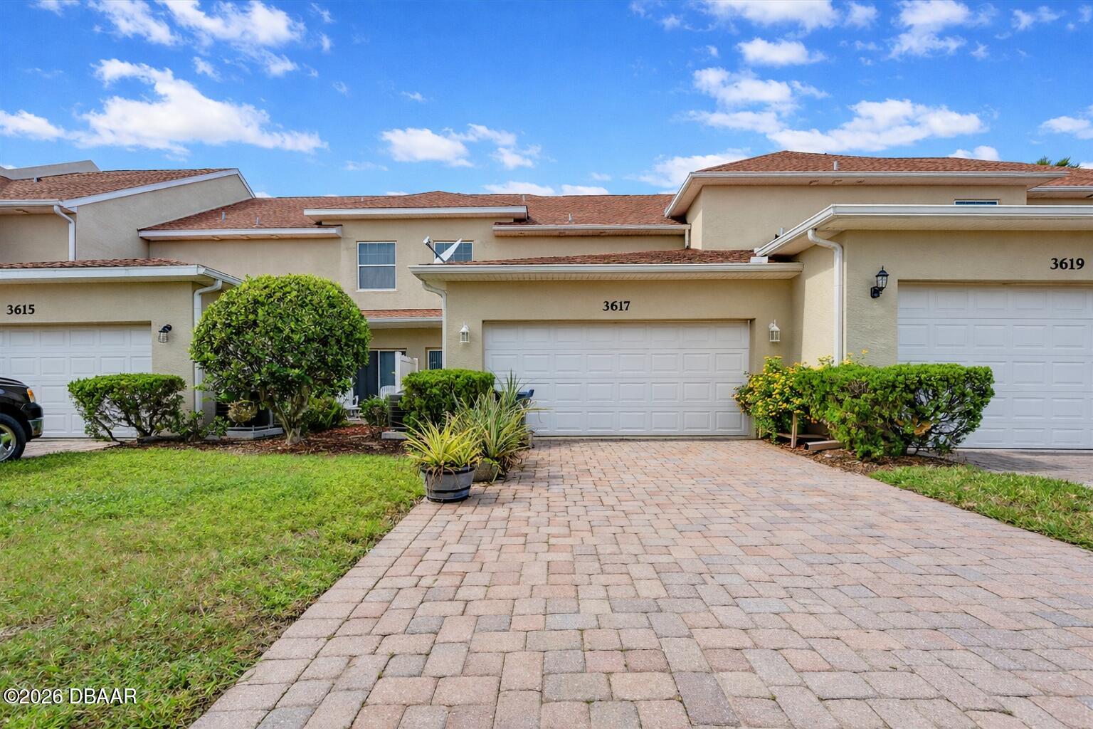 3617 Romea Circle New Smyrna Beach, FL 32168 - Photo 22 of 28 a front view of a house with garden