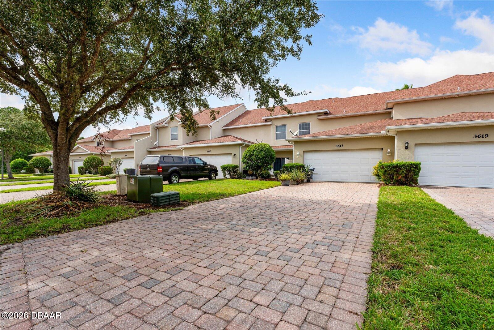 3617 Romea Circle New Smyrna Beach, FL 32168 - Photo 23 of 28 a front view of a house with a yard and garage
