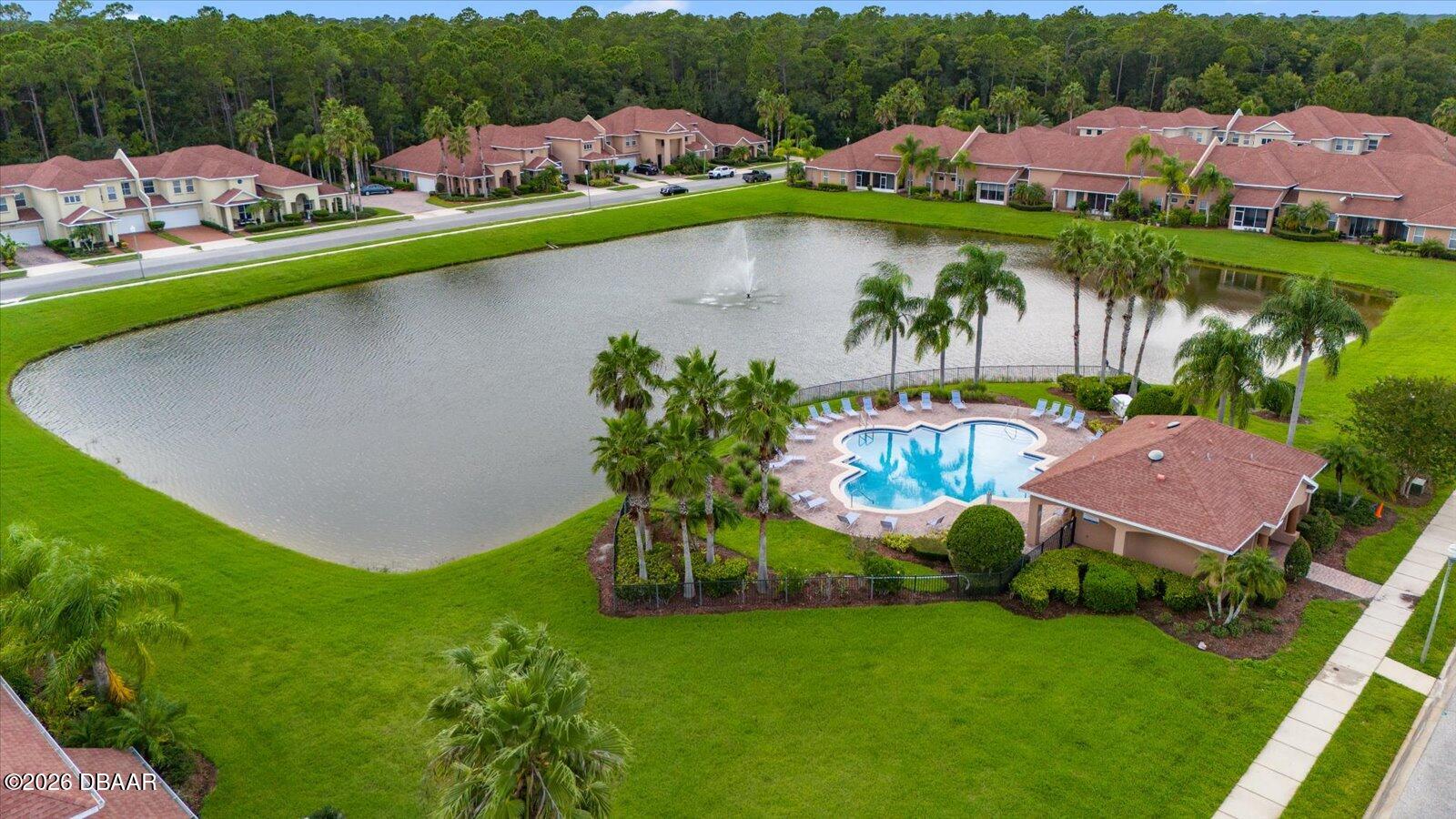3617 Romea Circle New Smyrna Beach, FL 32168 - Photo 25 of 28 an aerial view of a house with a garden and lake view