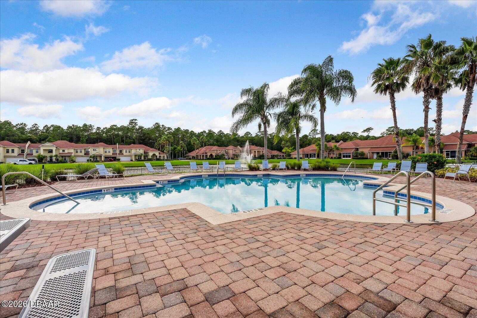 3617 Romea Circle New Smyrna Beach, FL 32168 - Photo 26 of 28 a view of swimming pool with outdoor seating and a garden