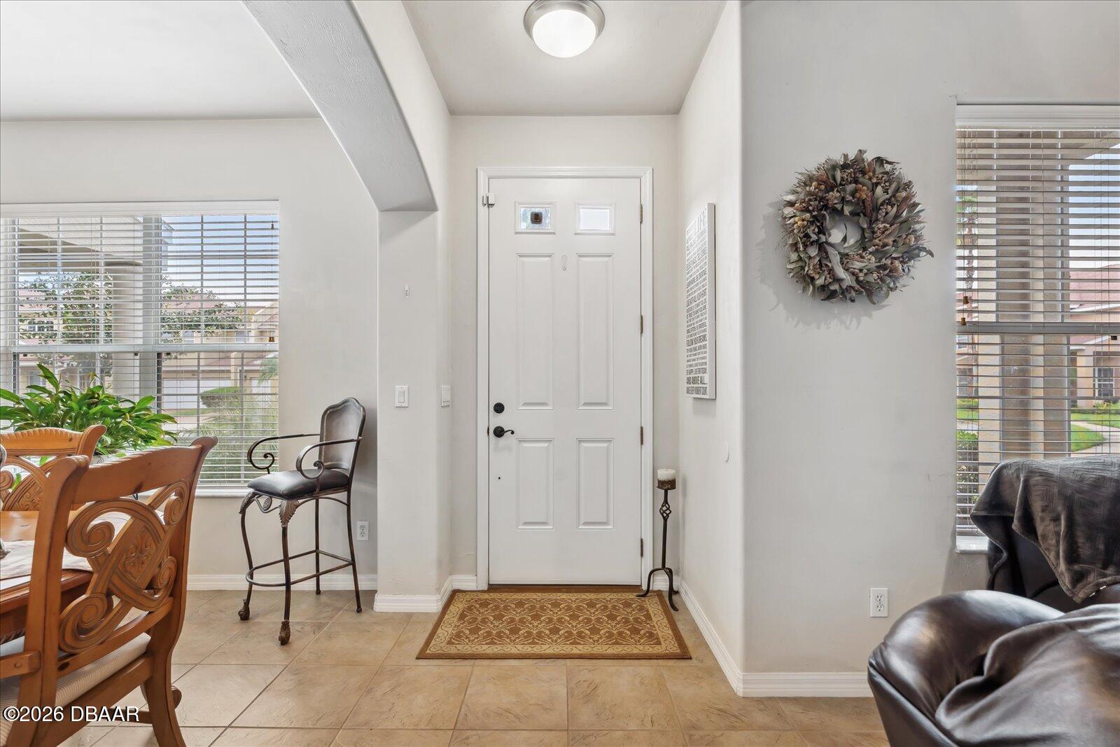 3617 Romea Circle New Smyrna Beach, FL 32168 - Photo 4 of 28 a view of a hallway with furniture and a potted plant