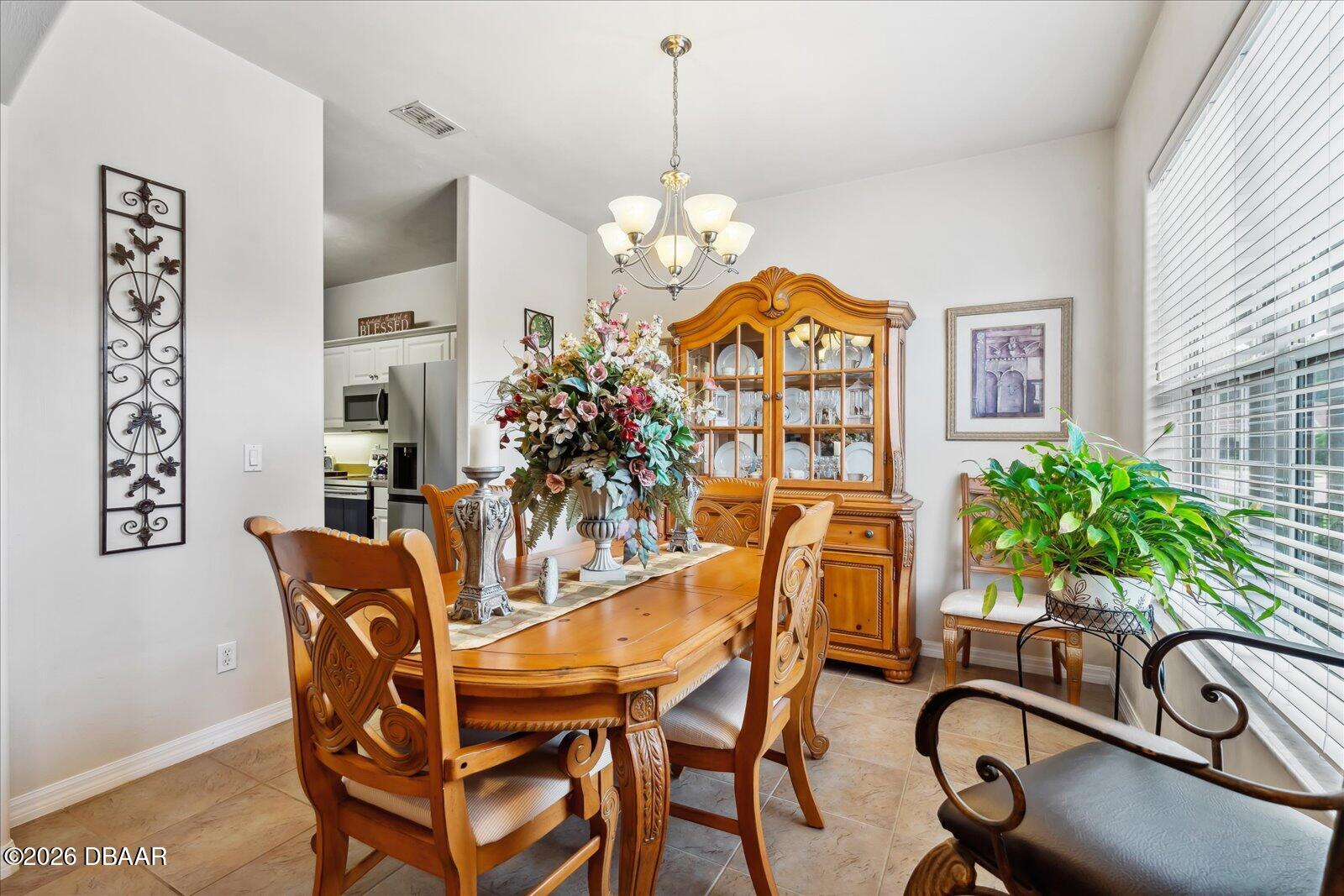 3617 Romea Circle New Smyrna Beach, FL 32168 - Photo 8 of 28 a view of a dining room with furniture window and flowerpot