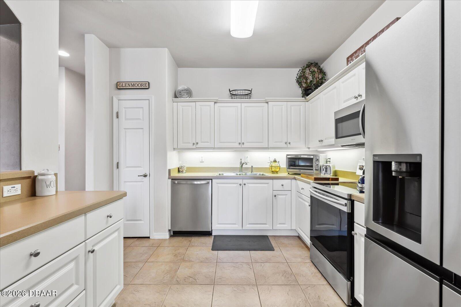 3617 Romea Circle New Smyrna Beach, FL 32168 - Photo 10 of 28 a kitchen with cabinets and stainless steel appliances