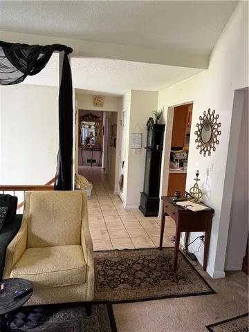 a kitchen with a sink and a stove with chairs