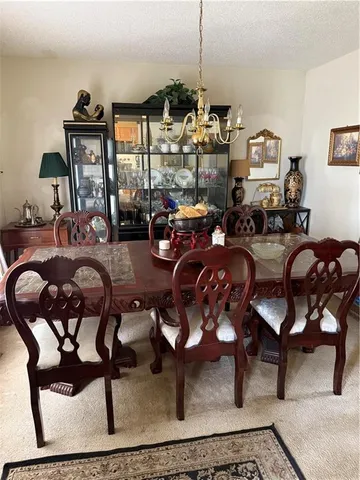 a view of a chairs and table on the wooden roof deck