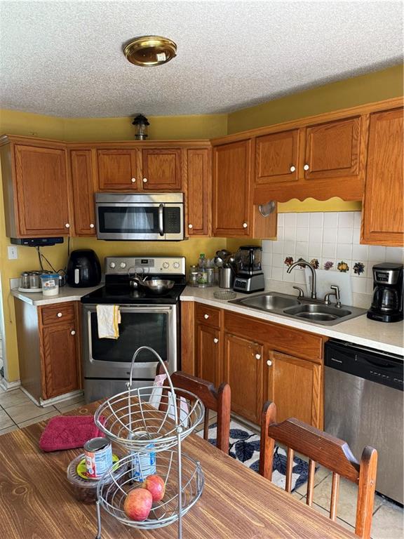 3903 Doe Run Drive Powder Springs, GA 30127 - Photo 19 of 60 a kitchen with stainless steel appliances a stove a sink dishwasher and cabinets with wooden floor