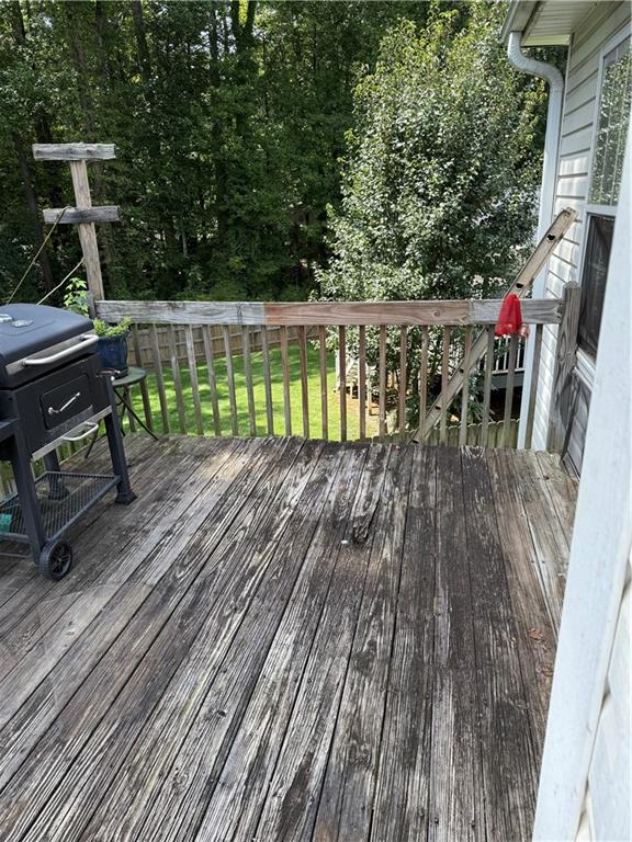 3903 Doe Run Drive Powder Springs, GA 30127 - Photo 20 of 60 a view of a chairs and table on the wooden roof deck