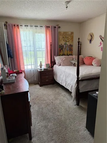 a bedroom with a bed and dresser