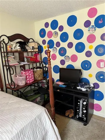 a view of walk in closet with clothes