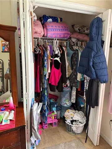 a bedroom with a bed and a television