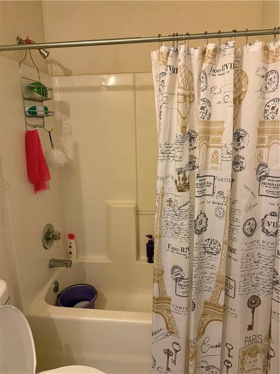 3903 Doe Run Drive Powder Springs, GA 30127 - Photo 33 of 60 a bathroom with a shower curtain and a bathtub