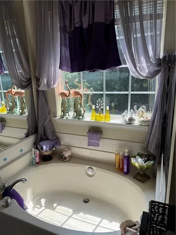 a view of walk in closet with clothes