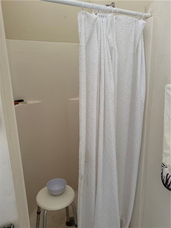 3903 Doe Run Drive Powder Springs, GA 30127 - Photo 40 of 60 a bathroom with a shower curtain and sink