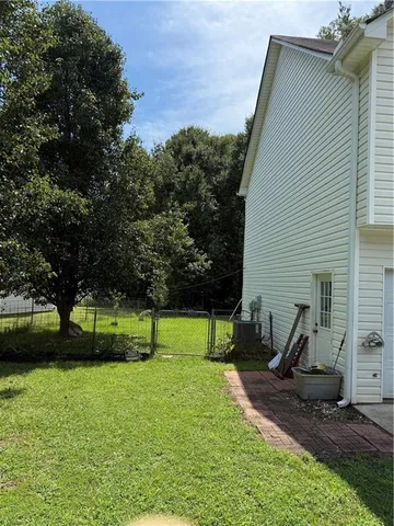 a view of a house with backyard and sitting area