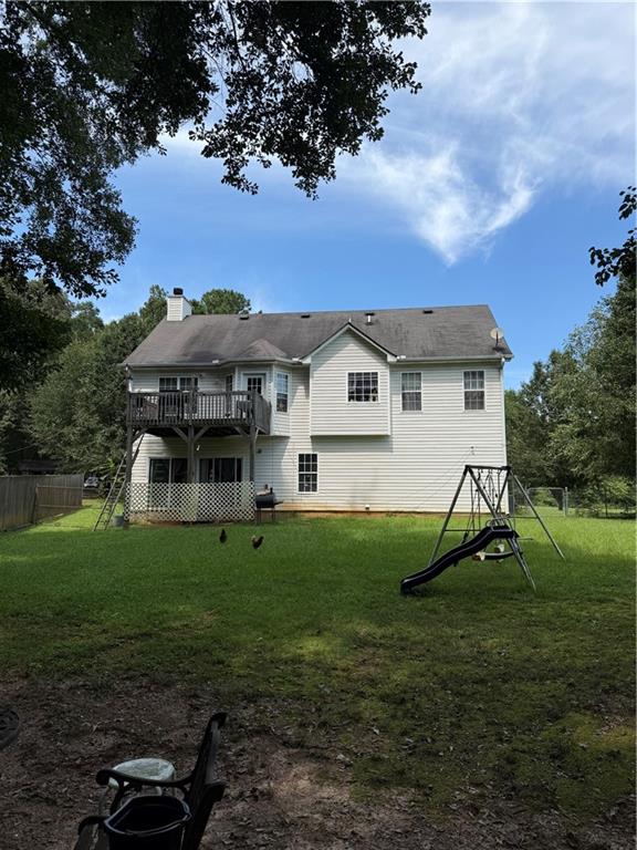 3903 Doe Run Drive Powder Springs, GA 30127 - Photo 10 of 60 a view of a house with a big yard and a large tree