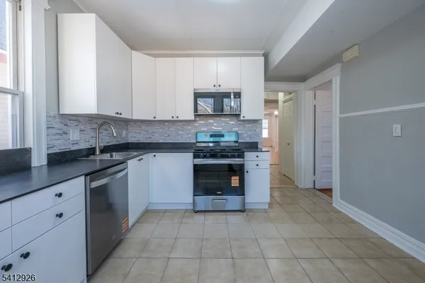a kitchen with stainless steel appliances granite countertop a stove and a sink