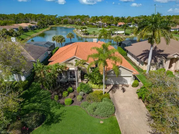 an aerial view of residential houses with outdoor space and river