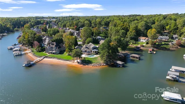 an aerial view of a houses with a lake view