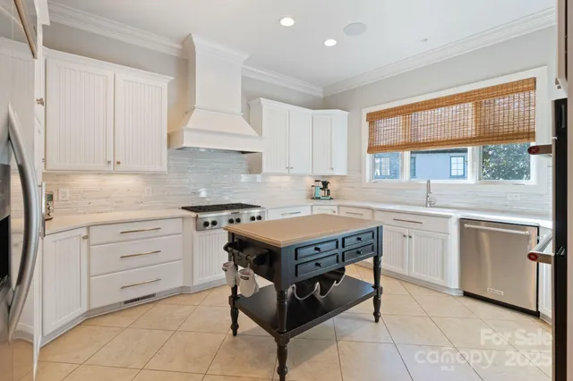 a kitchen with granite countertop a stove sink and cabinets