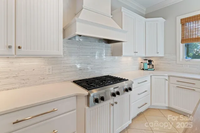 a kitchen with white cabinets and appliances