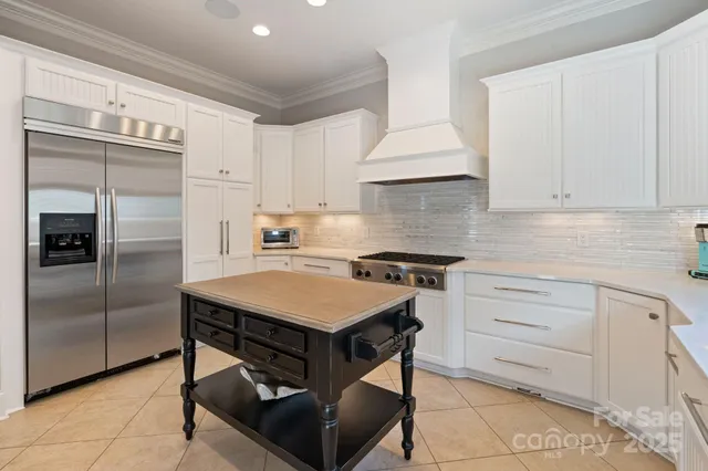 a kitchen with a sink a refrigerator and cabinets