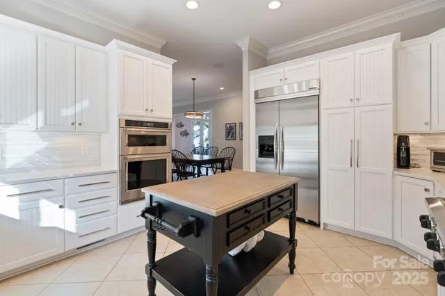 a kitchen with a stove a refrigerator and cabinets