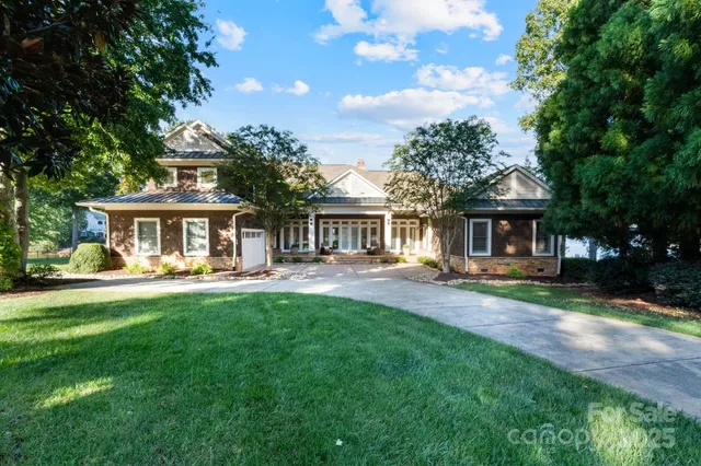 a front view of a house with yard patio and green space
