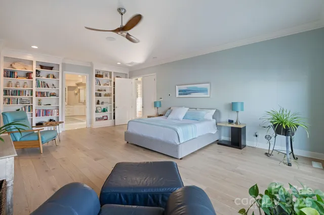 a bedroom with furniture and a large window