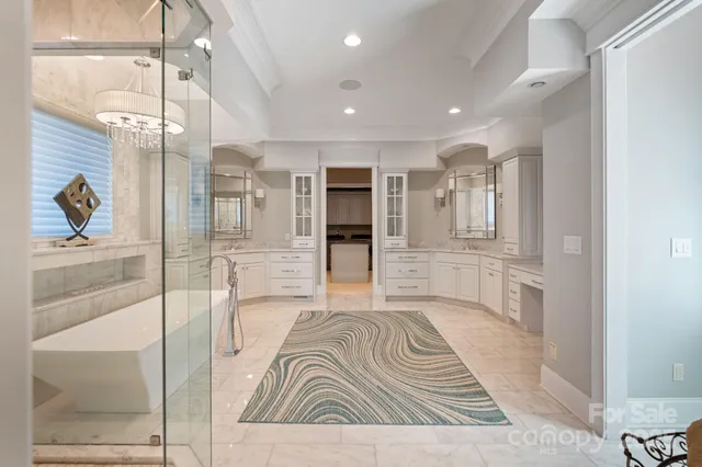 a living room with stainless steel appliances kitchen island granite countertop furniture and a rug