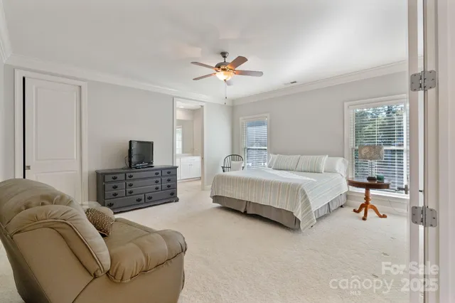 a bedroom with furniture and a flat screen tv