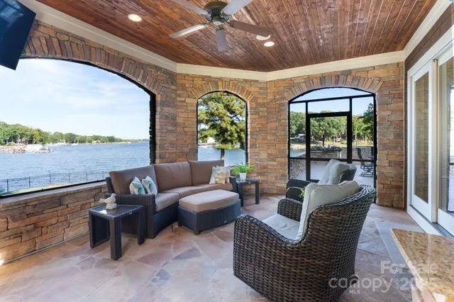 a living room with furniture and a floor to ceiling window
