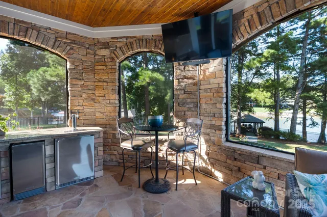 a view of a patio with table and chairs and potted plants