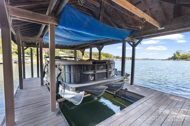 a view of a balcony with chairs and wooden floor