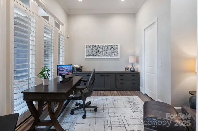 a view of a workspace with furniture and a window