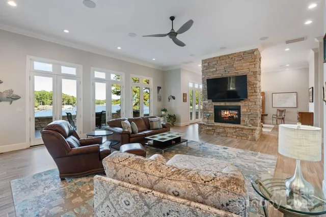 a living room with furniture a fireplace and a flat screen tv