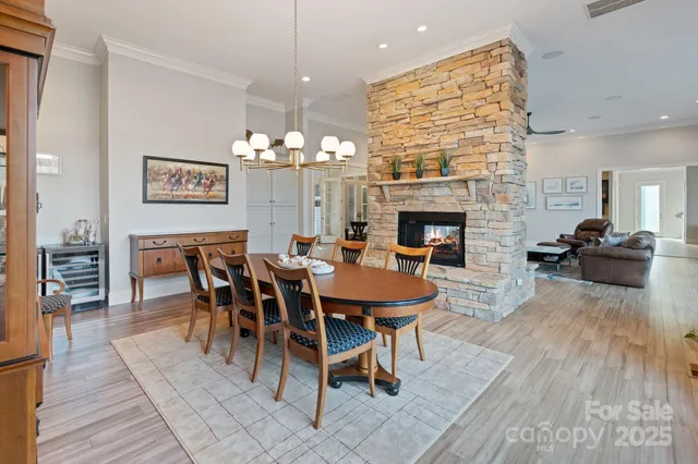 a view of a a dining room with furniture window and wooden floor