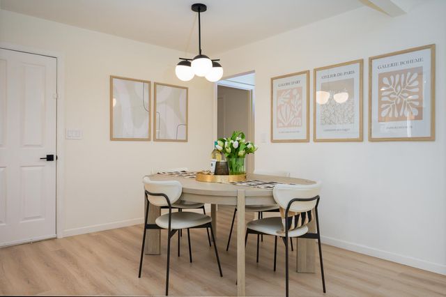 a view of a dining room with furniture wooden floor and a chandelier