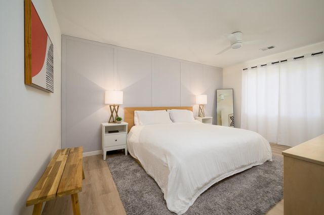 a bedroom with a bed and a mirror