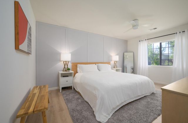 a bedroom with a bed and a window