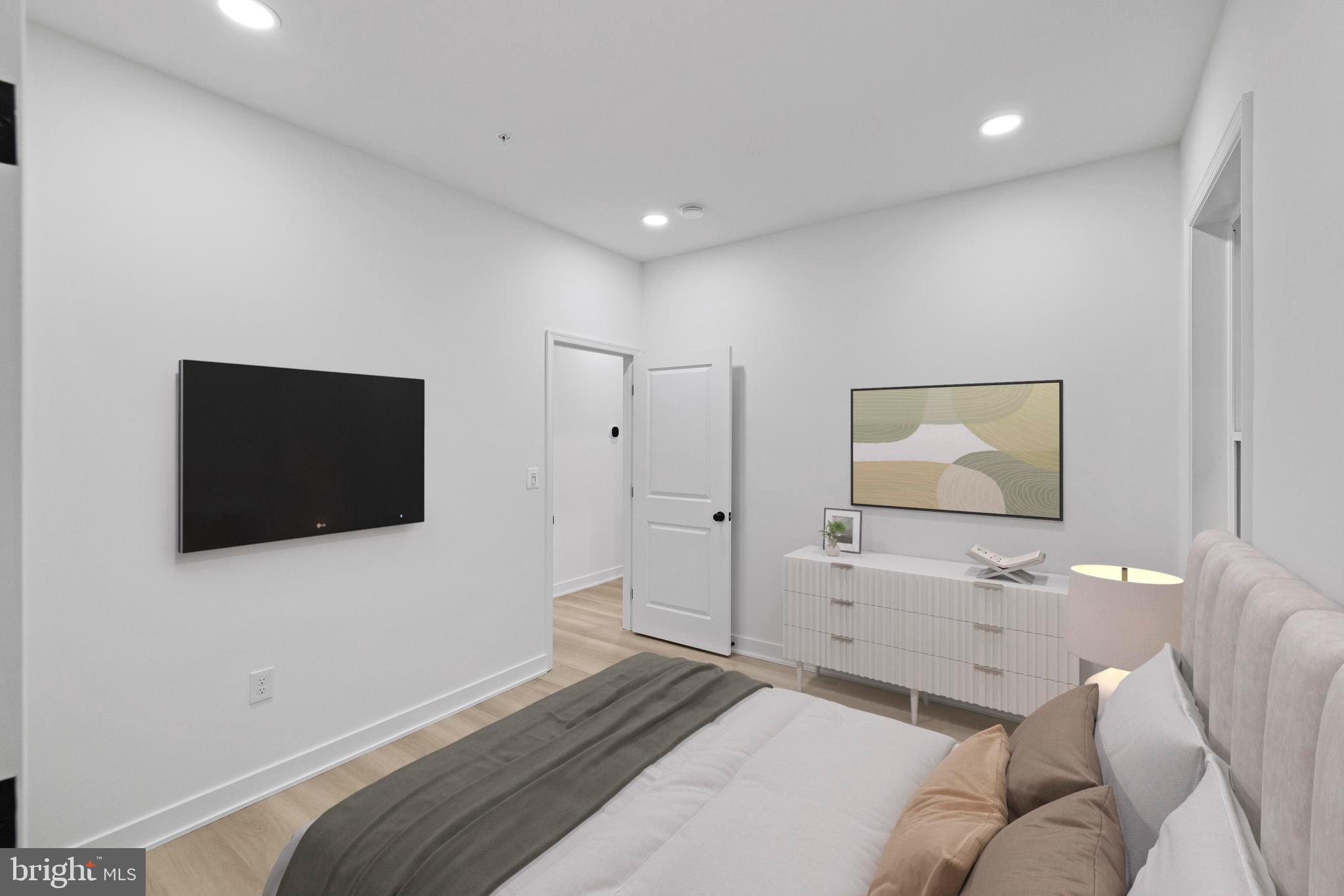 237 Brock Bridge Road Laurel, MD 20724 - Photo 17 of 64 a bedroom with a bed and a flat screen tv